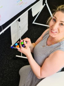 Circle 5 Woman at drawing board holding lots of coloured pens
